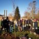A Green Impact Team, dressed in outdoor wear and holding shovels, coming together for a tree planting activity on campus.