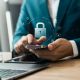 The image shows an illustration of a padlock above a phone and laptop.