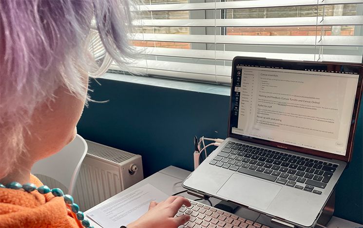 Person using computer to access Canvas